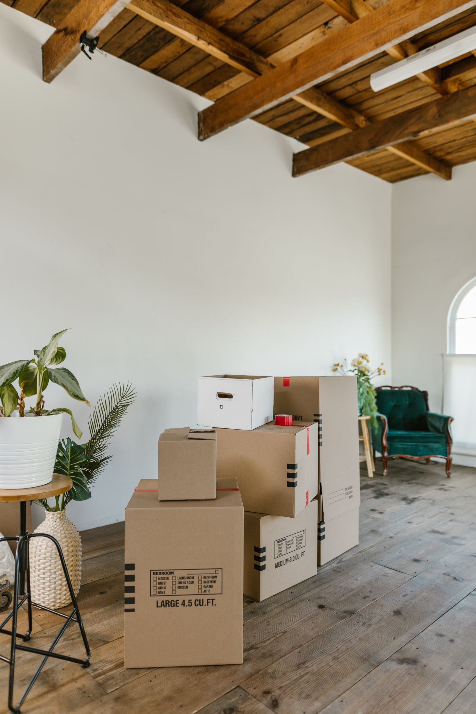 Cardboard moving boxes in an empty room before a pre move in cleaning in Marietta, GA